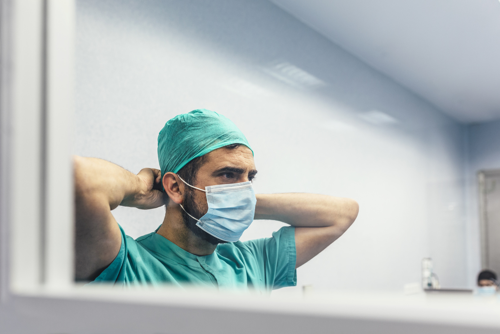 Surgeon adjusting his cap before surgery